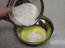 Batter making: mixing the flour into the egg.